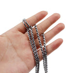 Dog training chain collar held in hand, showcasing its durable design and flexibility for training pets.